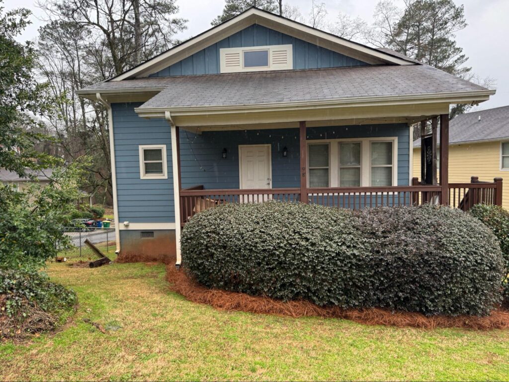 Blue house exterior with crawl space vents, highlighting the importance of crawl space restoration for hidden issues