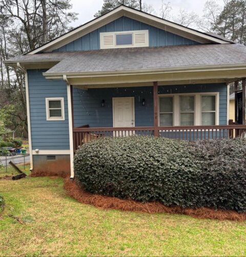 Blue house exterior with crawl space vents, highlighting the importance of crawl space restoration for hidden issues